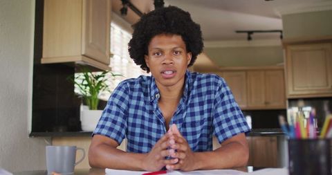 Serious African American Man on Video Call in Modern Kitchen