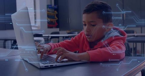 Young student typing on laptop with digital circuit overlay for coding and STEM learning