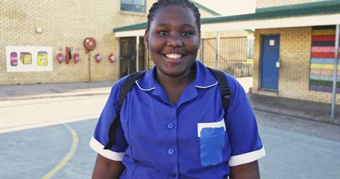 Smiling African Schoolgirl in Uniform at Elementary School Playground
