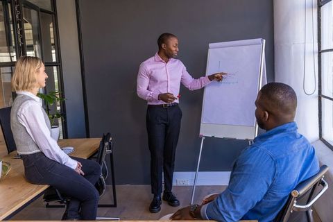 Professional Team Discussing Data Trends in Modern Office