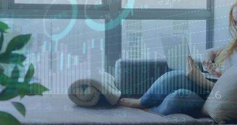 Woman Using Laptop in Lounge with Financial Data Overlay