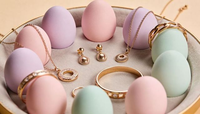 Displaying pastel egg props with gold jewelry on velvet tray