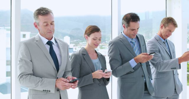 Businesspeople Texting on Smartphones in Modern Office - Download Free Stock Photos Pikwizard.com