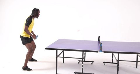 Energetic Athlete Playing Table Tennis Indoors