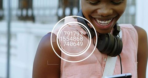 Smiling woman checking smartphone with headphones and digital hud overlay on urban sidewalk