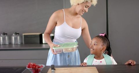 Mother Preparing Nutritious Meal with Daughter in Kitchen