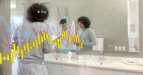 Young men viewing augmented reality financial charts on bathroom mirror before work