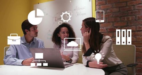 Team brainstorming around laptop with digital icons for collaboration and cloud innovation