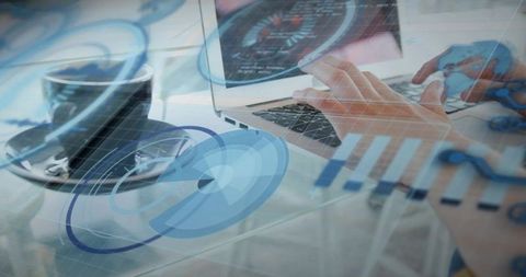 Typing Hands Overlaid with Futuristic HUD Data Visualizations on Glass Desk Workspace