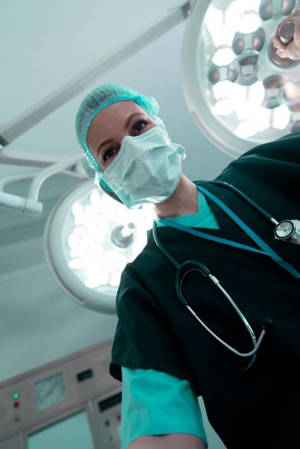 Smiling Female Surgeon Adjusting Light in Operating Room - Download Free Stock Images Pikwizard.com