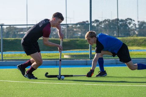Competitive male field hockey dual on synthetic turf pitch