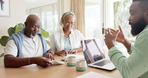 Senior Couple Consulting with Financial Advisor at Home