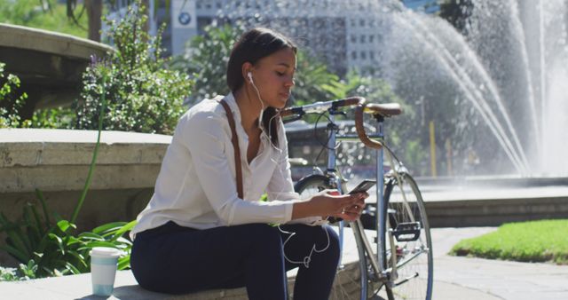 Relaxed Businesswoman Sitting at Outdoor Park with Bicycle, Listening to Music - Download Free Stock Images Pikwizard.com