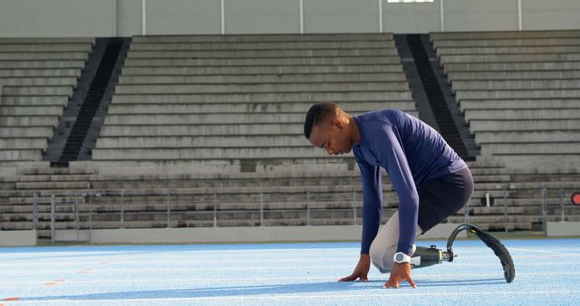 Determined Para Athlete Preparing for Sprint on Stadium Track - Download Free Stock Images Pikwizard.com