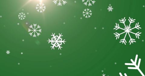 Snowflakes on green background with bright light