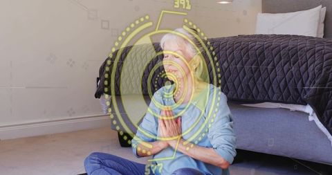 Senior woman meditating beside bed with digital wellness hud overlay for mindfulness