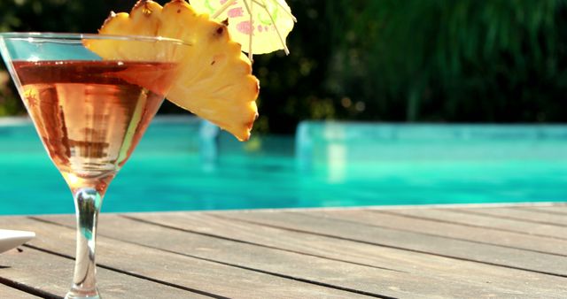 Close-up of Tropical Cocktail by Poolside with Pineapple Slice and Umbrella - Download Free Stock Images Pikwizard.com