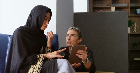 Diverse Businesswomen Collaborating on Tablet in Modern Office - Download Free Stock Images Pikwizard.com