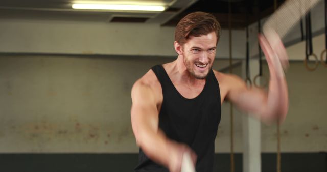 Fit man exercising with battle ropes in gym - Download Free Stock Images Pikwizard.com