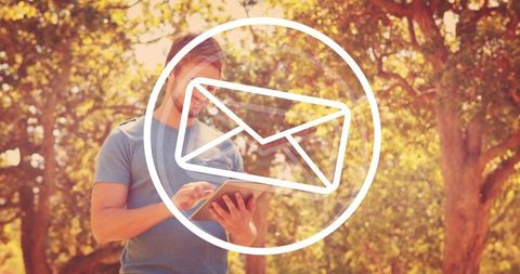 Man using tablet in sunlit forest with envelope icon overlay for mobile email