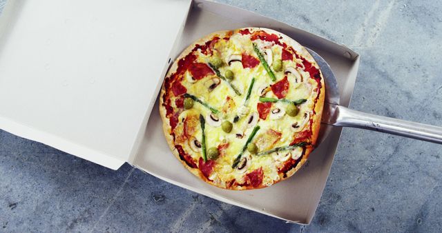 Freshly Baked Pizza in Open Box with Spatula on Concrete Surface - Download Free Stock Images Pikwizard.com