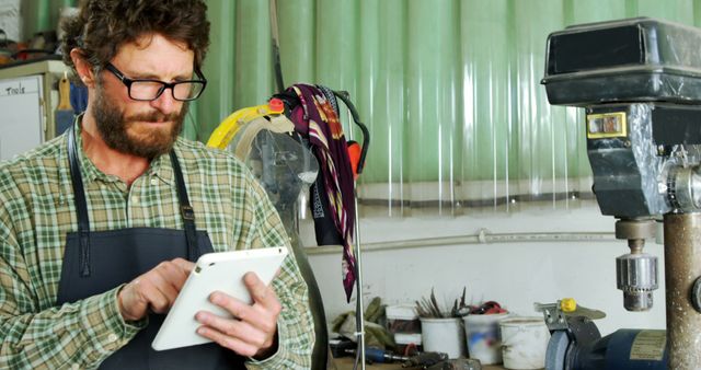 Bearded Craftsman Using Digital Tablet in Workshop - Download Free Stock Images Pikwizard.com