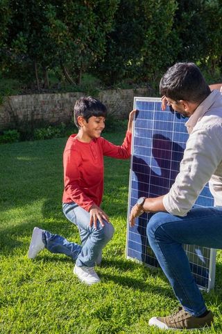 Father and son collaborating on solar energy installation