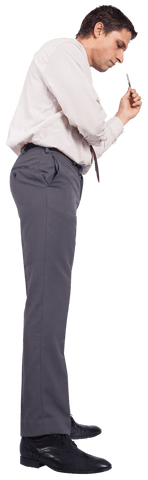 Focused Businessman Examining Pen with Curiosity on Transparent Background