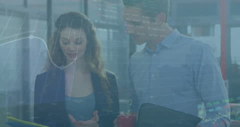 Colleagues Analyzing Stock Market Data with Digital Interface