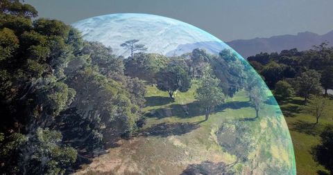 Translucent globe overlaying sunlit meadow aerial view, futuristic planet dome concept