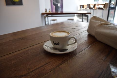 Coffee Cup on Rustic Wooden Table in Modern Café - Download Free Stock Images Pikwizard.com