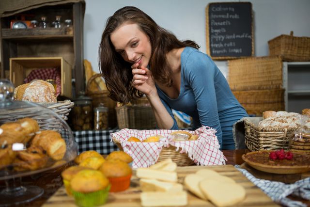 Excited woman purchasing sweet food at bakery counter in market