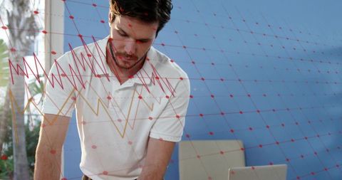 Analyzing interactive data overlay while working on laptop in bright modern office