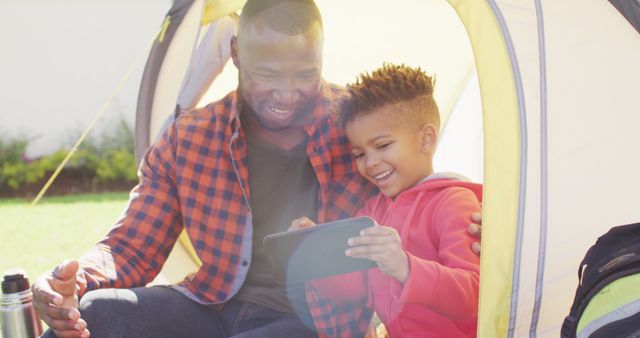 Father and Son Camping and Using Tablet in Tent - Download Free Stock Images Pikwizard.com