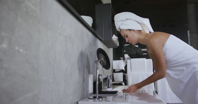 Woman Grooming at Bathroom Sink with Towel Head Wrap - Download Free Stock Images Pikwizard.com