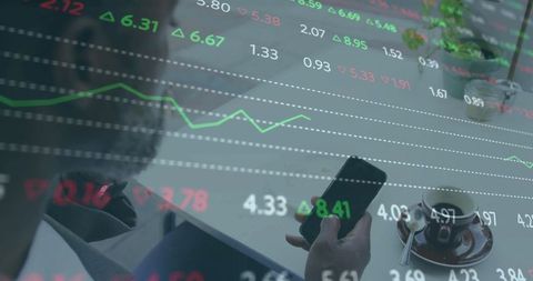 Investor checking market tickers on smartphone with stock charts overlay at coffee table