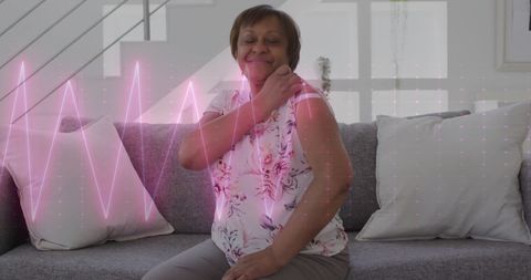 Senior Woman Monitoring Health with Digital Cardiograph Display