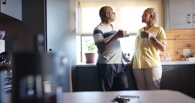 Senior Couple Relaxing with Coffee in Sunlit Kitchen - Download Free Stock Images Pikwizard.com