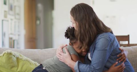 Loving Mother Comforting Daughter at Home