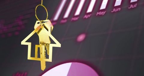 Hanging gold house keychain and keys over financial dashboard with bar chart and pie graph