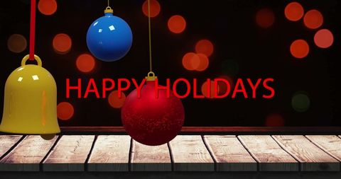 Festive Holiday Greeting with Baubles and Bell on Rustic Table