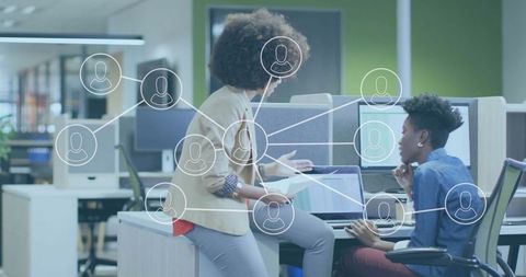 Diverse Women Team Collaborating in Modern Office with Digital Network