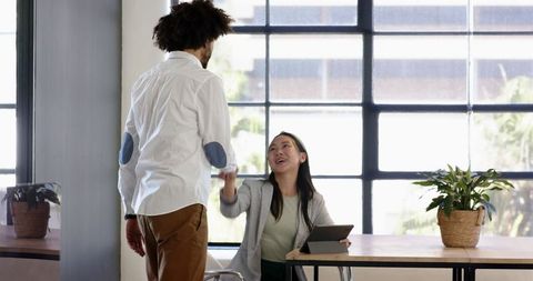 Business Colleagues Celebrating Successful Collaboration in Modern Office