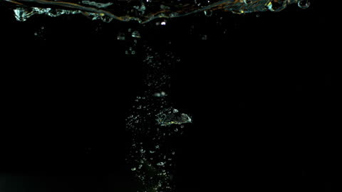 Lemon Slice Submerged in Water with Bubbles