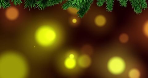 Festive christmas tree branches over glowing bokeh background