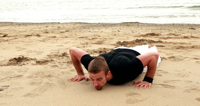 Man Performing Push-Ups on Beach Sand - Download Free Stock Images Pikwizard.com