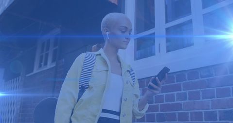 Stylish Woman Walking to Work Using Smartphone in Urban Street