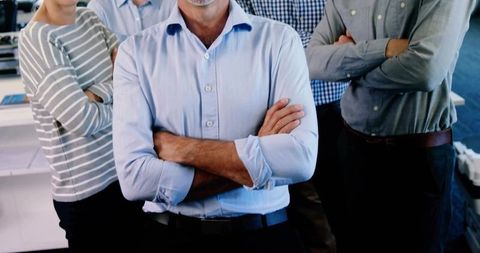 Confident Business Leader Standing with Team in Modern Office