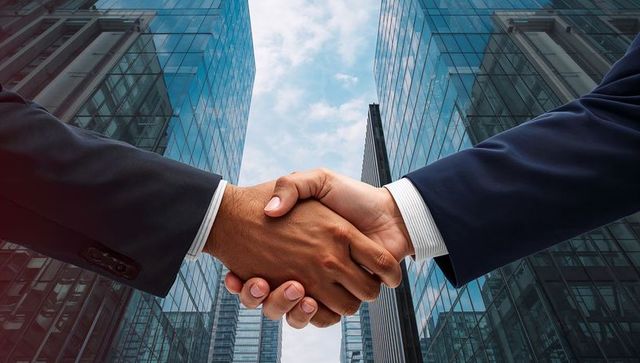 Businessmen Shaking Hands with Cityscape Background Reflecting Partnership