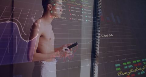 Businessman analyzing digital stock market charts by window